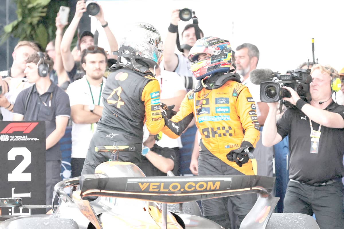 Lando Norris of Great Britain and McLaren congratulates race winner Oscar Piastri of Australia and McLaren in parc ferme during the F1 Grand Prix of Miami.