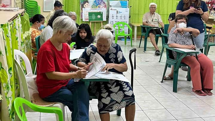 Senior citizens in Paltok Elementary School in Quezon City cast their votes, with the help of their relatives, on Monday.
