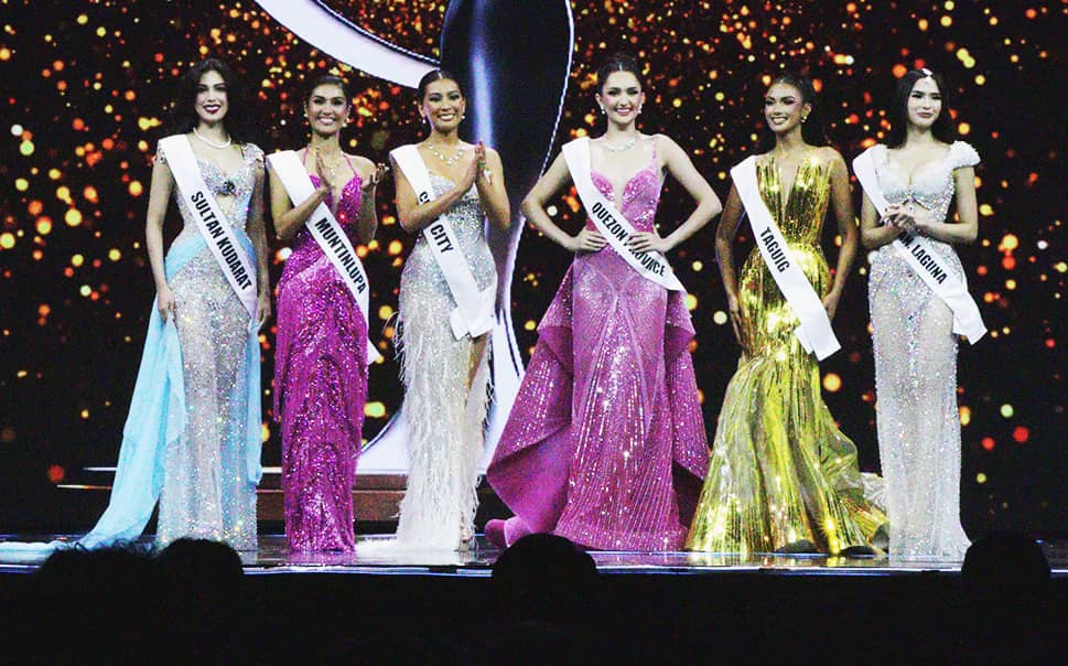 The stage fills with elegance and poise as the top 6 pose in their evening gowns.