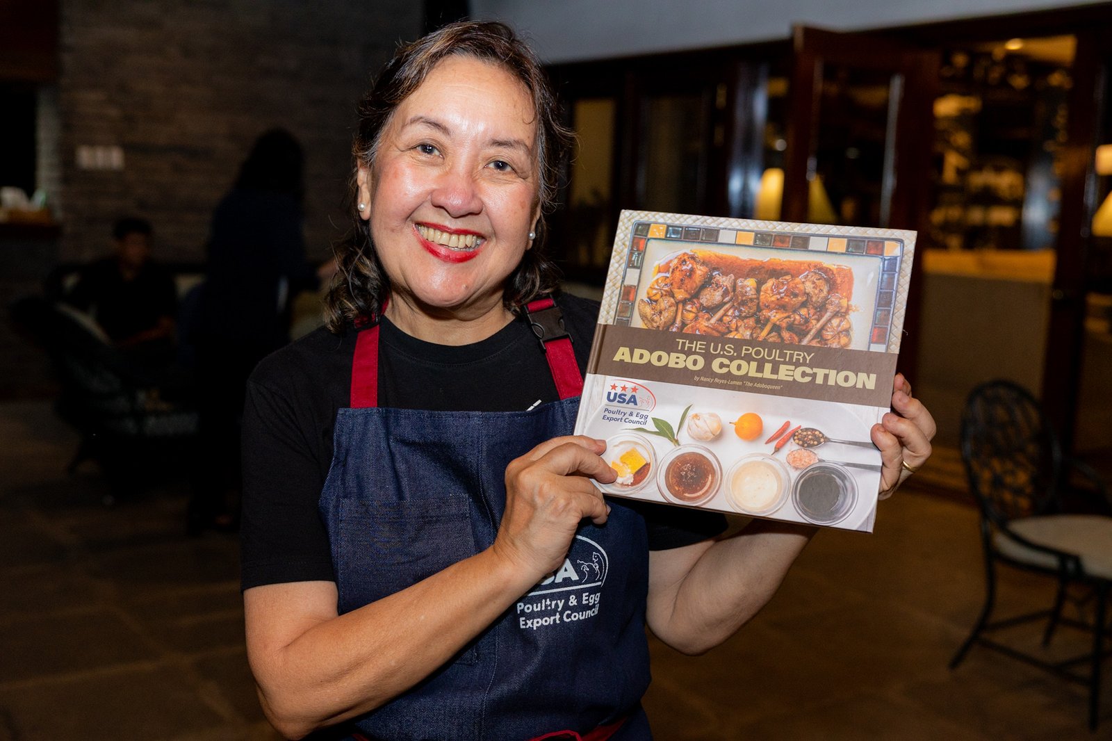 “Adoboqueen” Chef Nancy Reyes-Lumen shows a copy of the “U.S. Poultry Adobo Collection,” published with the support of the U.S. Department of Agriculture’s Foreign Agricultural Service in Manila, the USA Poultry and Egg Export Council, and the United Soybean Board.