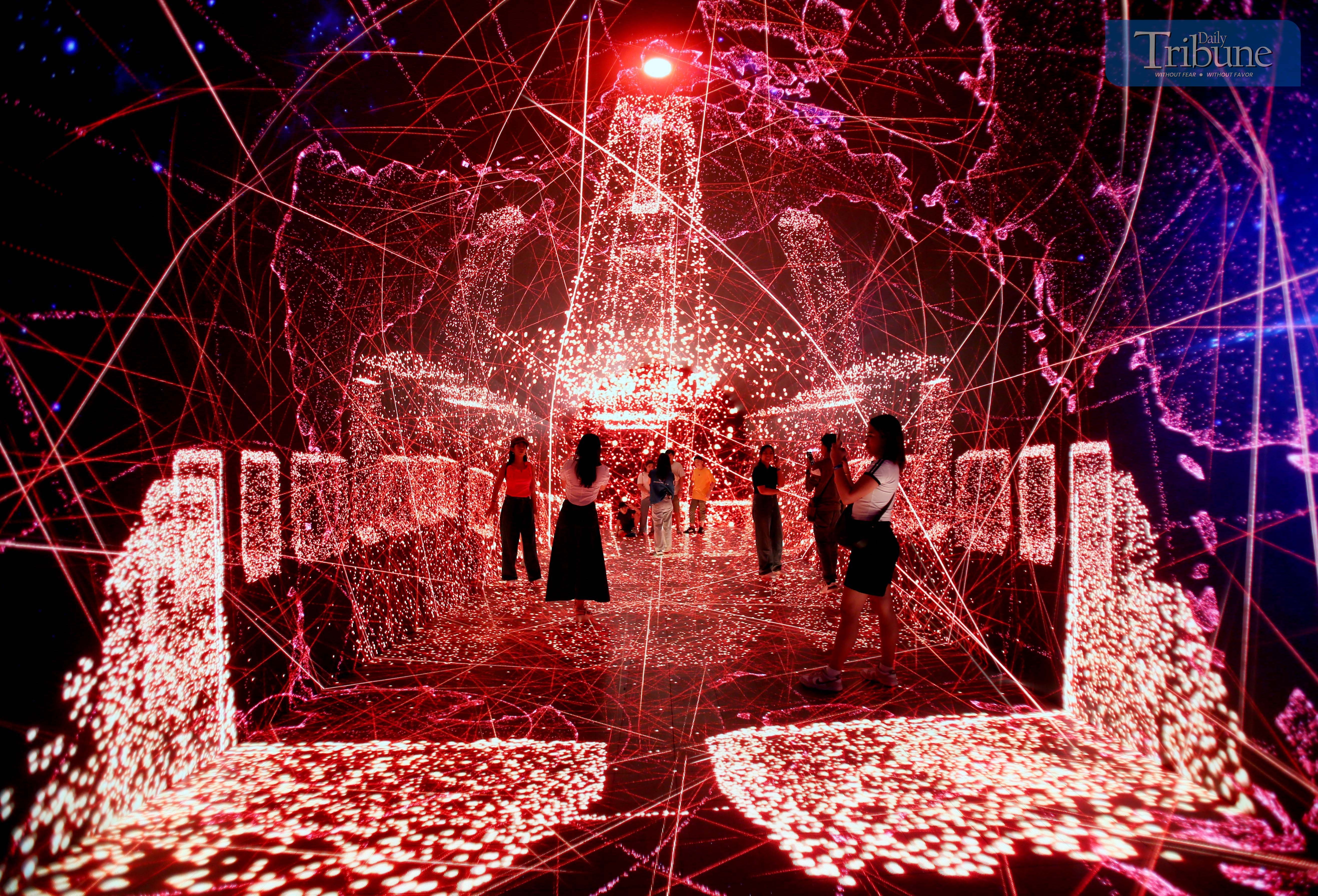 Guests take selfies and engage with various interactive displays at the newly opened Space and Time Cube+ immersive art museum at SM City North Edsa in Quezon City on Saturday, 17 May 2025.