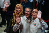 TOPNOTCHERS: Newly-proclaimed representatives from vote-leading party-list Akbayan, led by Chel Diokno, wave at Manila Hotel on Monday.