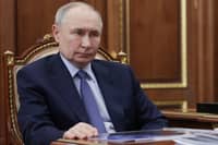 Russian President Vladimir Putin sits at a desk during a meeting with Promsvyazbank’s CEO at the Kremlin in Moscow on 15 May 2025, in a pool photograph released by Russian state agency Sputnik.