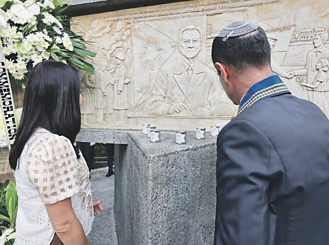 Fluss stands beside President Quezon’s memorial in Quezon City, where a quiet ‘yes’ once spoken still echoes through generations of gratitude.