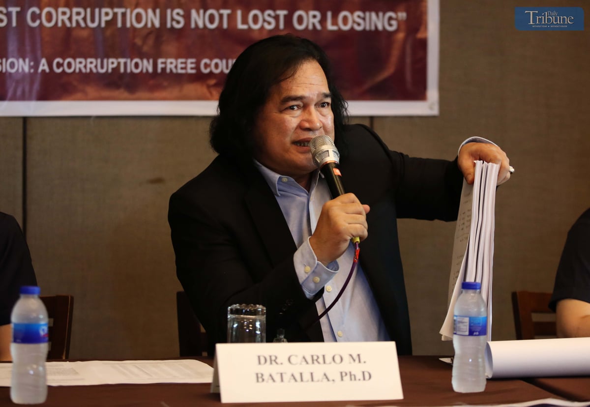 On Wednesday, 21 May 2025, during a press conference in Quezon City, Dr. Carlo Batalla, chairman of Crimes and Corruption Watch International, presents documents his group filed before the Office of the Ombudsman against top officials of the Department of Public Works and Highways–Region 6 and executives of a private construction firm over alleged irregularities involving P2.4 billion in bidding contracts.