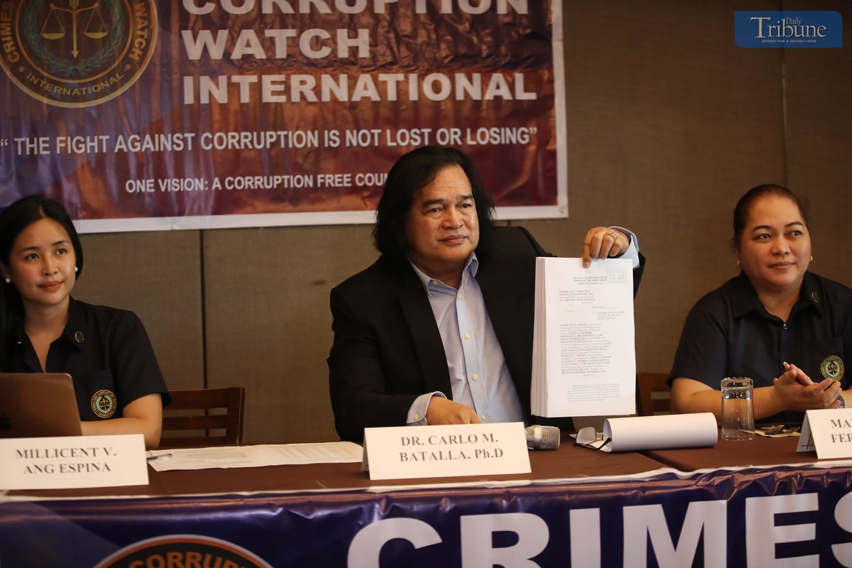 On Wednesday, 21 May 2025, during a press conference in Quezon City, Dr. Carlo Batalla, chairman of Crimes and Corruption Watch International, presents documents his group filed before the Office of the Ombudsman against top officials of the Department of Public Works and Highways–Region 6 and executives of a private construction firm over alleged irregularities involving P2.4 billion in bidding contracts.