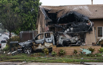 A home is partially destroyed and a vehicle burned out after a small plane crashed into a residential street in San Diego, California, on 22 May 2025. The Cessna 550, en route to Montgomery-Gibbs Executive Airport, went down around 3:45 a.m., leaving behind a large debris field and damaging at least 15 homes and cars, according to local officials.