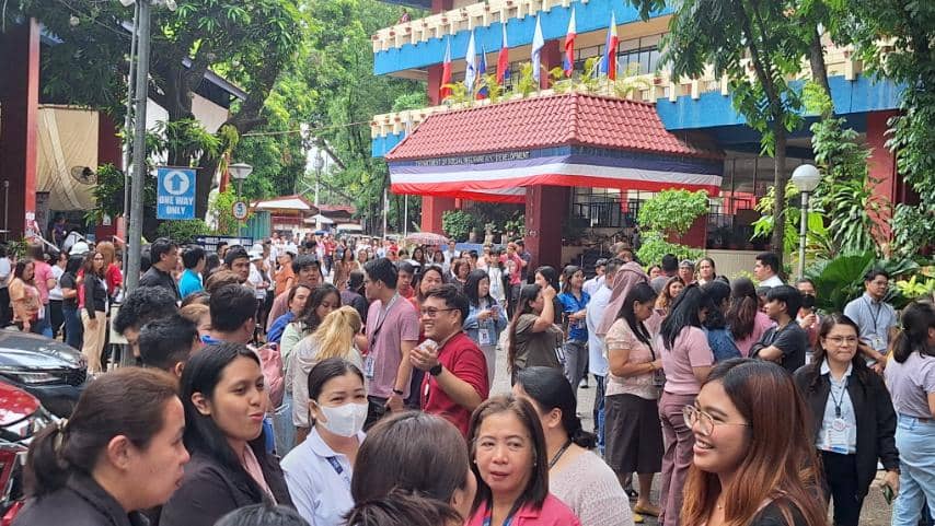 DSWD personnel evacuate to the open grounds of the agency’s Central Office following an earthquake felt across Metro Manila on Tuesday, 27 May.