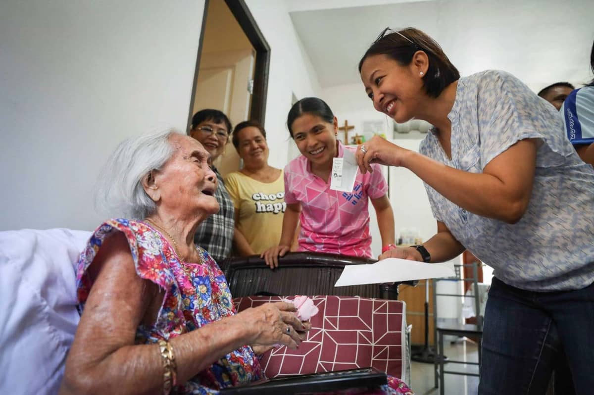 A HUGE smile and a check for a centenarian constituent.