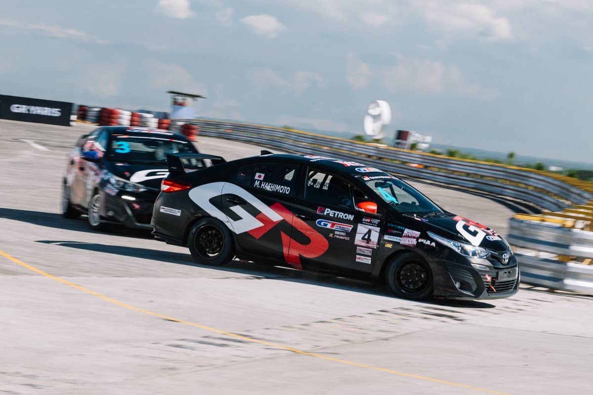 TMP president Masando Hashimoto leads a tight battle on the track.