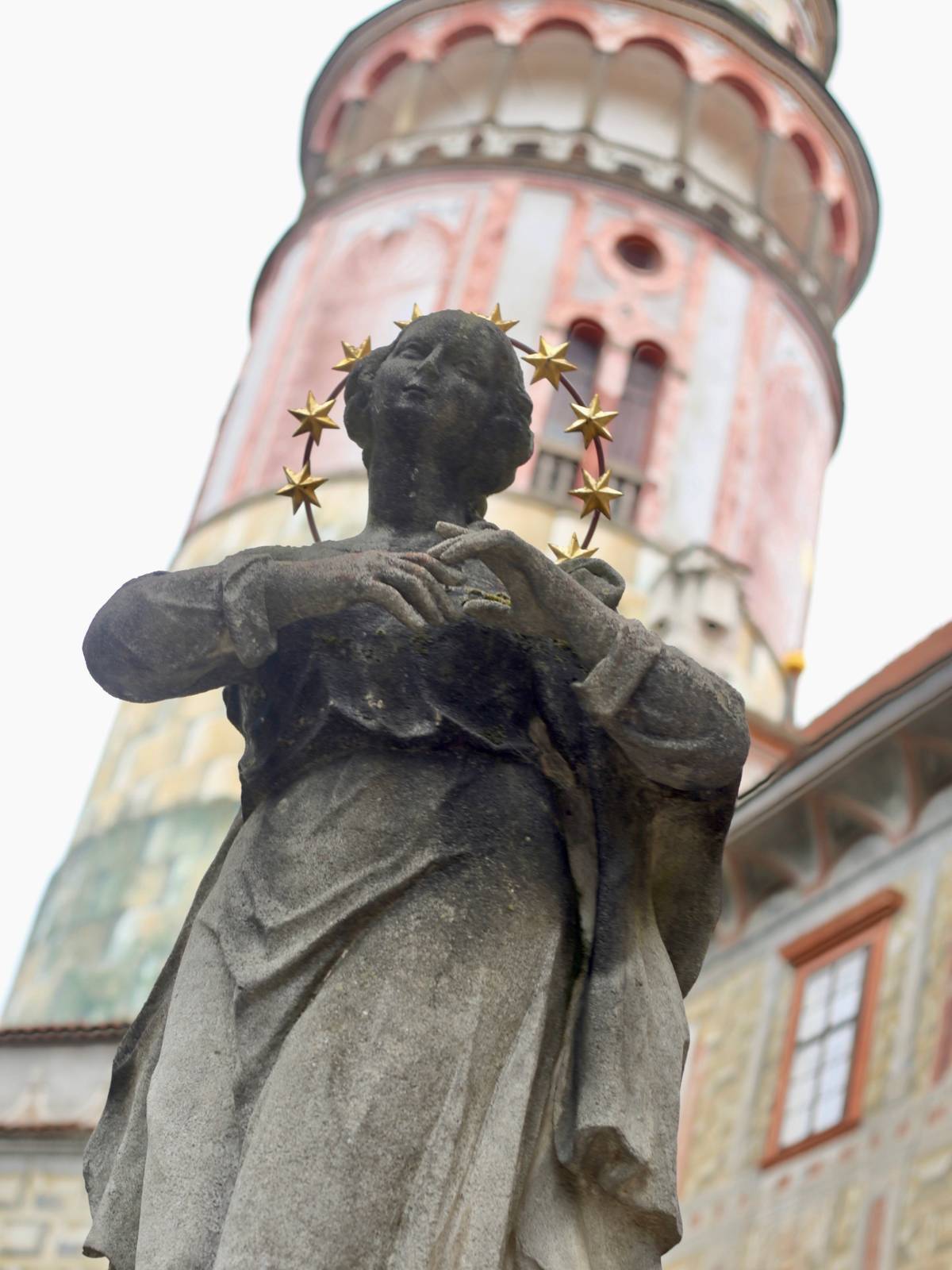 The castle courtyard is decorated with statues.