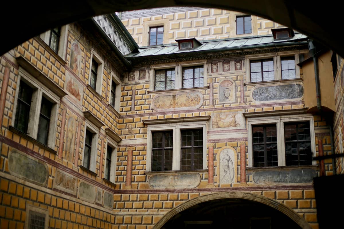 The castle courtyard, with its luxurious Renaissance-style exterior and ornate Gothic windows.