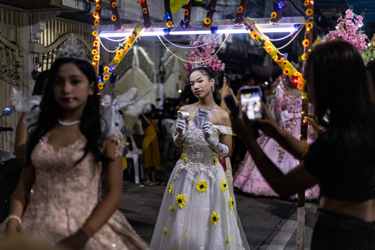 People take pictures of the Reynas during the Sagayla procession in Sampaloc, Manila on Sunday, 1 June 2025.