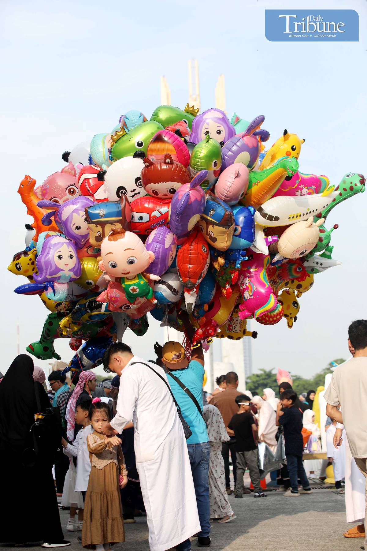 FILIPINO Muslim parents buy colorful balloons for their children during the Eid al-Adha celebration at Quezon City Circle on Friday, 6 June 2025.