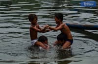 Boys cool off with a splash as they play in the waters of Navotas on Satuday, 7 June.