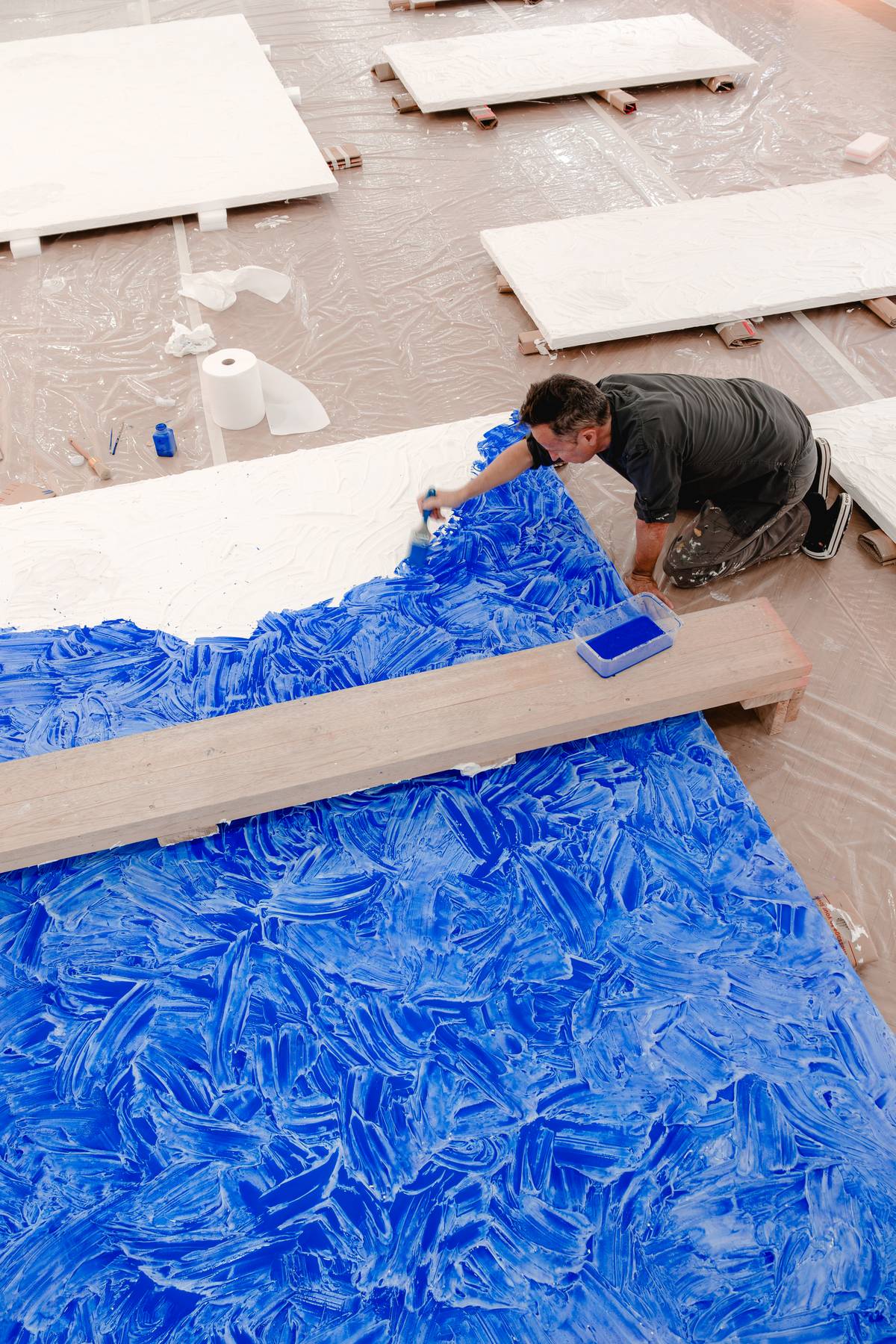 The artist paints the piece blue.