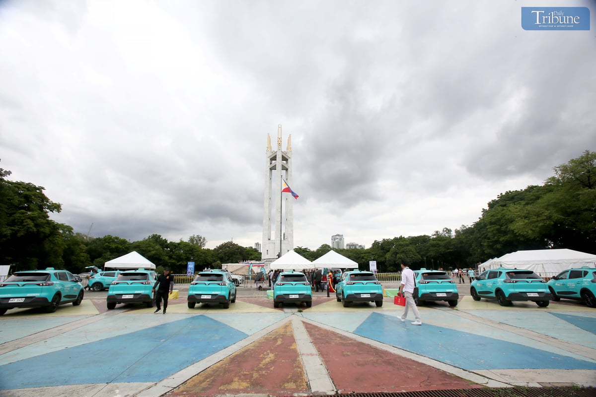 A Green GSM Philippines electric taxi is seen parked at Quezon City Memorial Circle on Tuesday, 10 June 2025, during the launch of the “Green and Smart Mobility” initiative. The event showcased sustainable transport solutions, electric vehicles, and smart mobility technologies aimed at promoting eco-friendly urban transport nationwide.