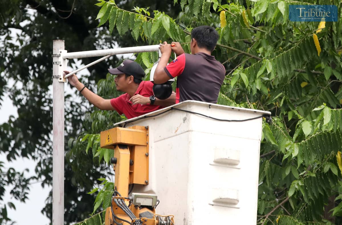 Metropolitan Manila Development Authority (MMDA) workers install closed-circuit television (CCTV) cameras at Batasan Road, North Gate of the House of Representatives in Quezon City on Wednesday, 11 June 2025.
