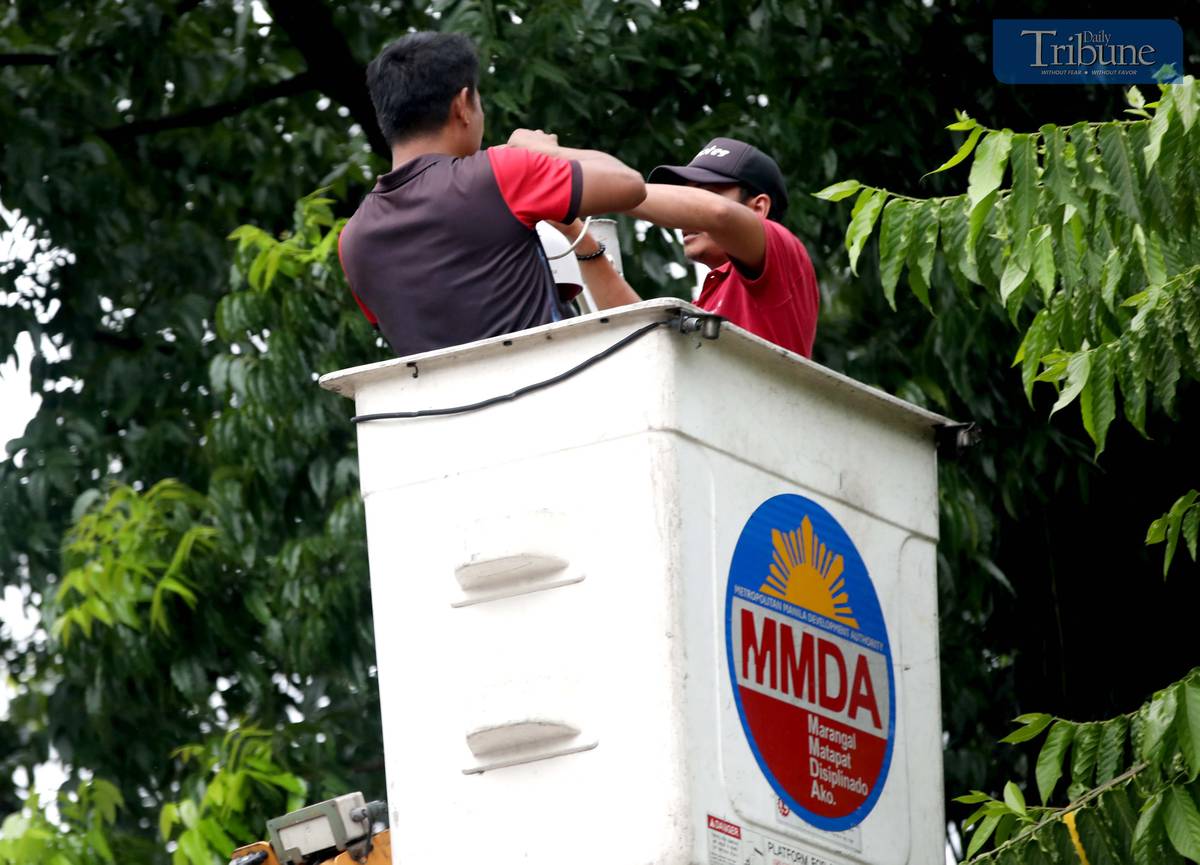 Metropolitan Manila Development Authority (MMDA) workers install closed-circuit television (CCTV) cameras at Batasan Road, North Gate of the House of Representatives in Quezon City on Wednesday, 11 June 2025.