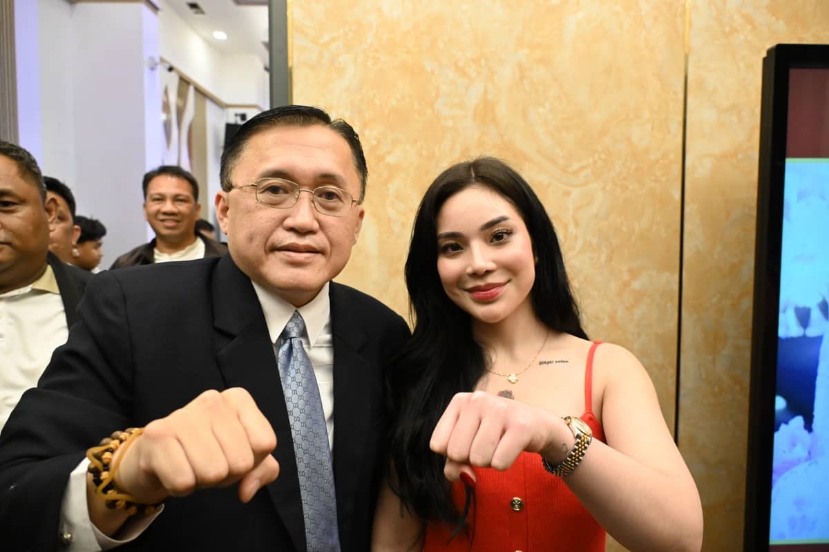 Senator Bong Go poses with a fist bump alongside Kitty Udring during a Thanksgiving party in Manila celebrating his Senate win.