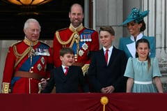 A royal wave: Prince Louis charms by King Charles' side on palace balcony