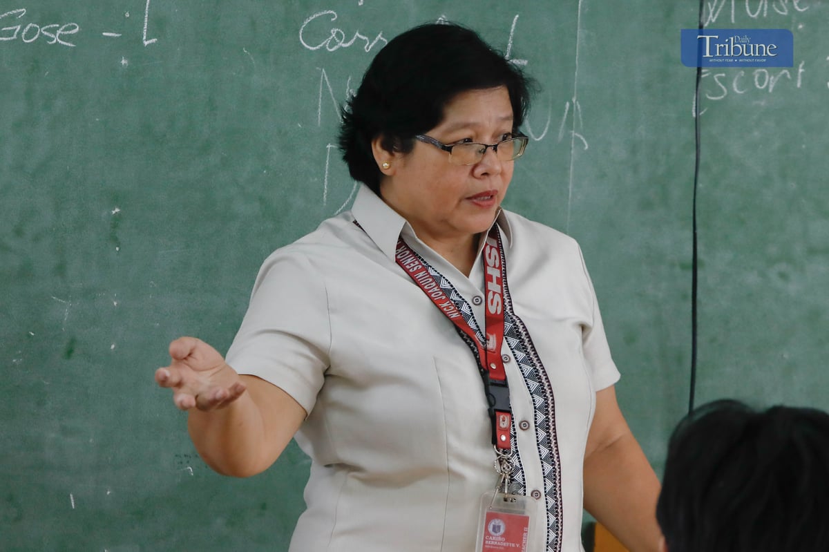 STUDENTS listen to their teacher at Nick M. Joaquin Senior High School in Quezon City during the first day of classes, Monday, 16 June 2025.