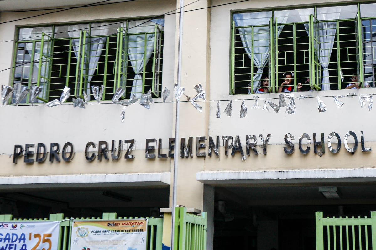 Kinder and elementary pupils of Pedro Cruz Elementary School join warm-up activities led by their teachers on the first day of classes, Monday, 16 June 2025.