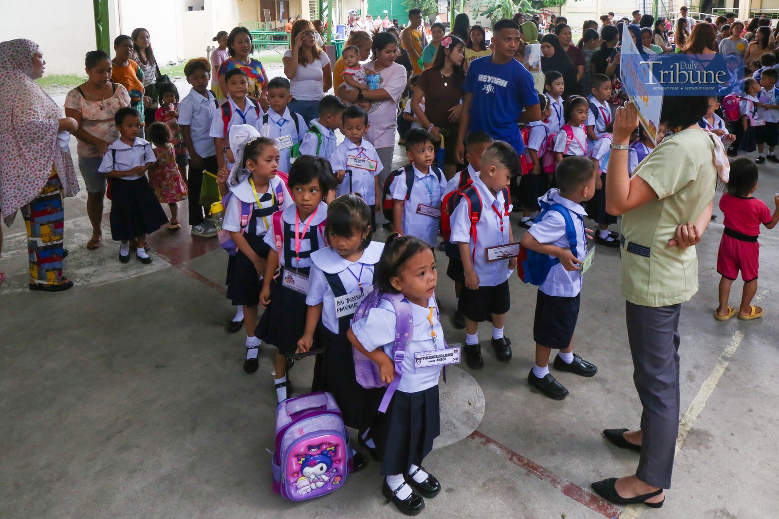 Parents accompany their children to a kindergarten school in Manila on Monday, 16 June 2025, marking the official start of the June-to-March academic year.