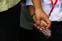 Parents accompany their children to a kindergarten school in Manila on Monday, 16 June 2025, marking the official start of the June-to-March academic year.