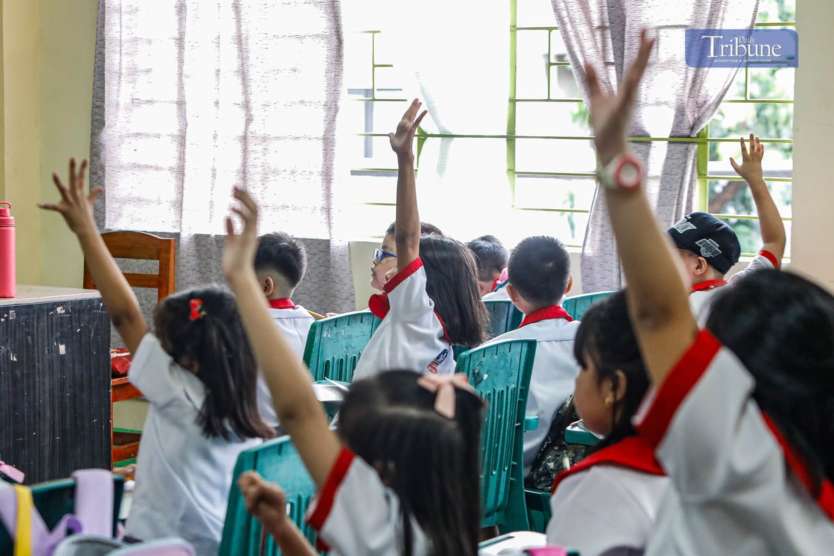 Kinder and elementary pupils of Pedro Cruz Elementary School join warm-up activities led by their teachers on the first day of classes, Monday, 16 June 2025.
