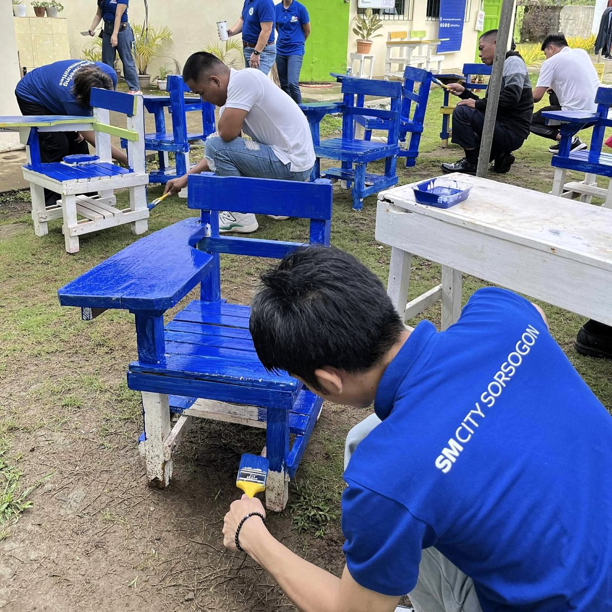 EMBODYING the spirit of bayanihan, SM City Sorsogon employee volunteers paint school chairs with dedication — bringing new life to classrooms through Brigada Eskwela.