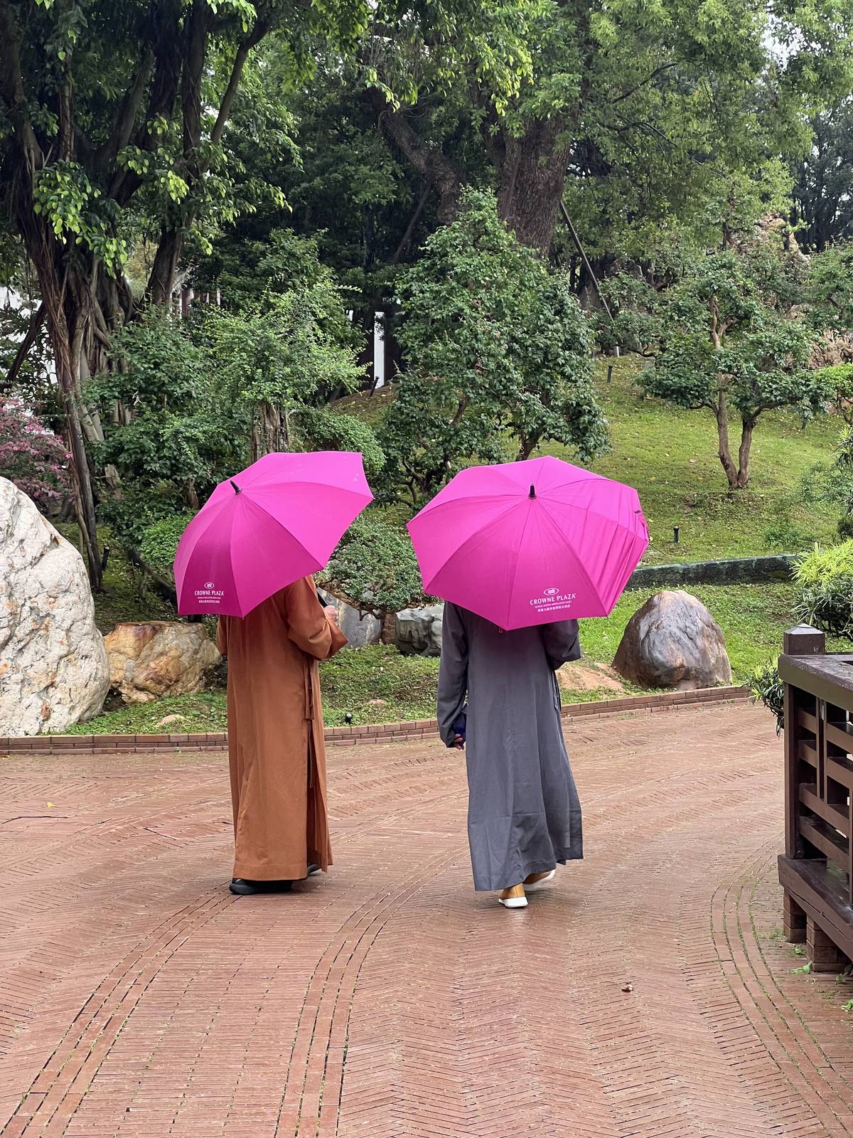 Raindrops from heaven Nuns with pink umbrellas explore the meditative grounds.