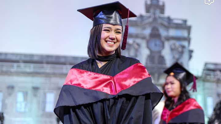 Mikee Quintos marches inside the Quadricentennial Pavilion as one of the 318 graduates of the College of Architecture