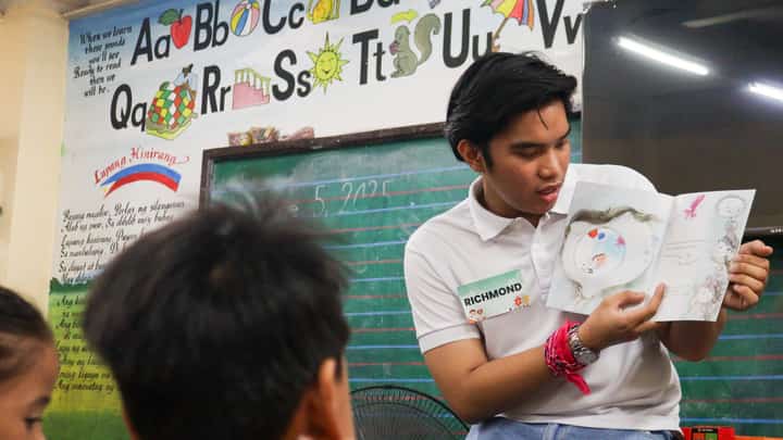 Generously giving back Scholars embody community spirit by actively participating in outreach initiatives like Brigada Eskwela, helping young students prepare for a new school year through a reading session.