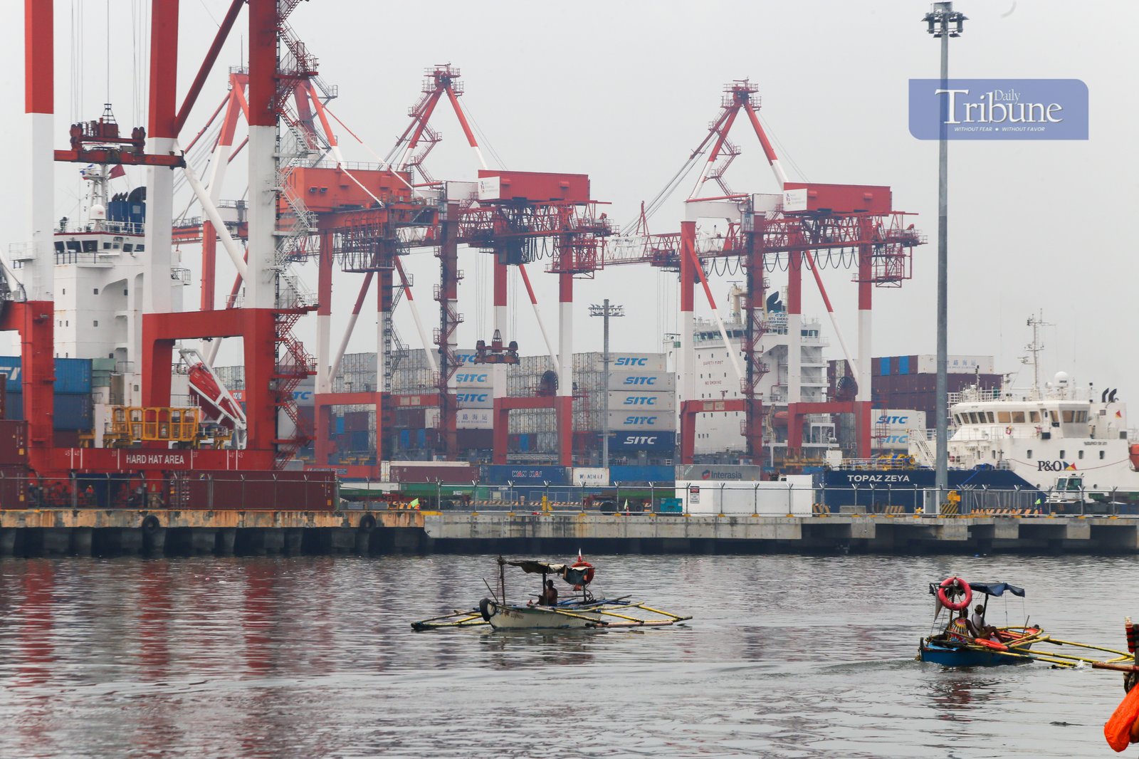 Heavy lifters load container vans onto a waiting trailer truck at a port terminal in Manila. The ongoing Iran-Israel conflict has notably affected Philippine imports and exports, mainly through disruptions in global oil prices, fertilizer supplies, and shipping routes.