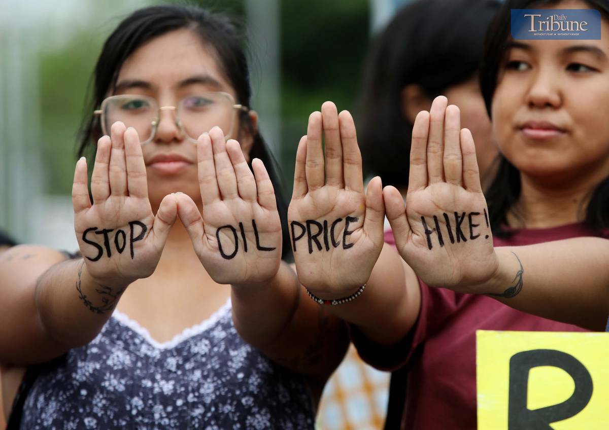 MEMBERS of Bayan Muna and other militant groups stage a protest at Philcoa, Commonwealth Avenue in Quezon City on Monday to denounce the looming fuel price hike, expected to go up by as much as P5 per liter. The protesters accused oil firms of capitalizing on the escalating Middle East conflict to jack up prices, and urged the government to repeal the Oil Deregulation Law and nationalize the oil industry to shield the public from speculative price shocks.