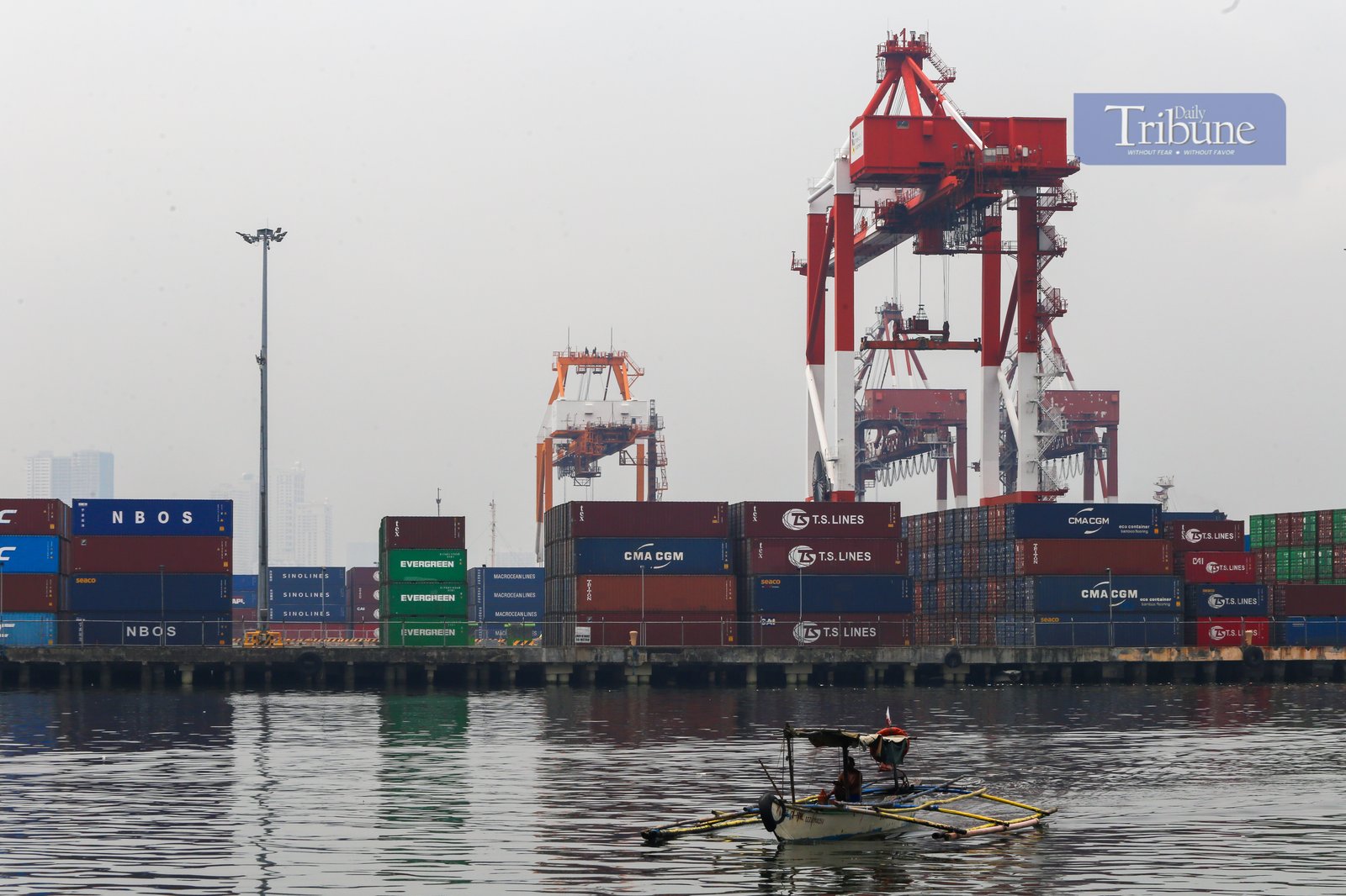 Heavy lifters load container vans onto a waiting trailer truck at a port terminal in Manila. The ongoing Iran-Israel conflict has notably affected Philippine imports and exports, mainly through disruptions in global oil prices, fertilizer supplies, and shipping routes.