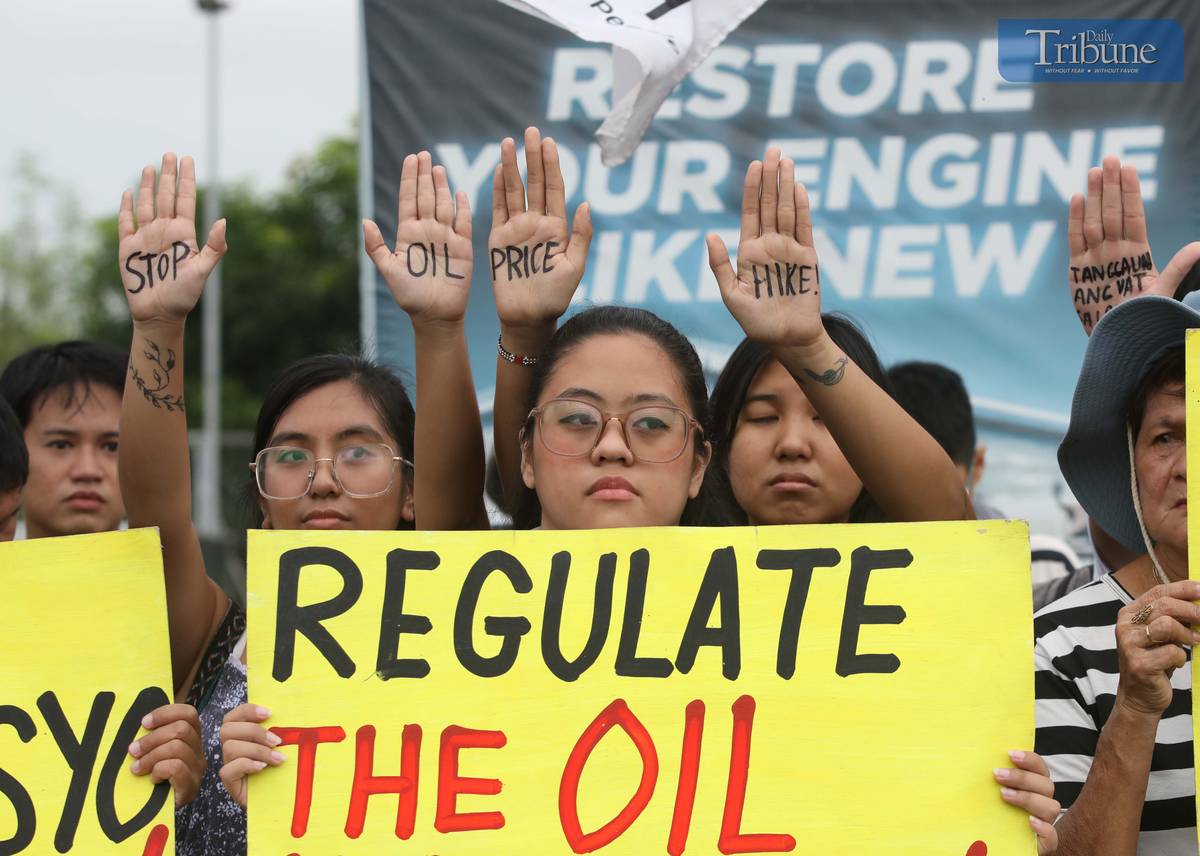 MEMBERS of Bayan Muna and other militant groups stage a protest at Philcoa, Commonwealth Avenue in Quezon City on Monday to denounce the looming fuel price hike, expected to go up by as much as P5 per liter. The protesters accused oil firms of capitalizing on the escalating Middle East conflict to jack up prices, and urged the government to repeal the Oil Deregulation Law and nationalize the oil industry to shield the public from speculative price shocks.