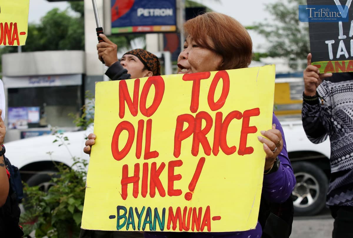 MEMBERS of Bayan Muna and other militant groups stage a protest at Philcoa, Commonwealth Avenue in Quezon City on Monday to denounce the looming fuel price hike, expected to go up by as much as P5 per liter. The protesters accused oil firms of capitalizing on the escalating Middle East conflict to jack up prices, and urged the government to repeal the Oil Deregulation Law and nationalize the oil industry to shield the public from speculative price shocks.