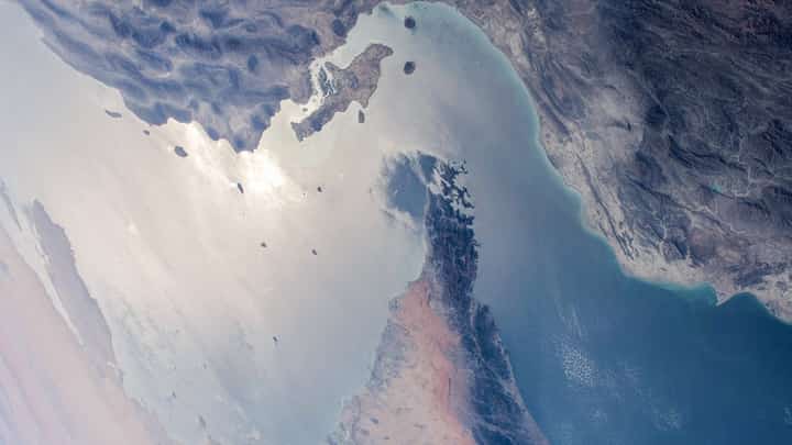 (FILES) This handout photo released by NASA and taken on 8 April 2021 by the Expedition 64 crew from the International Space Station shows a view of the Strait of Hormuz in the Gulf separating Iran (top) from the United Arab Emirates and Oman (bottom).
A senior United Arab Emirates official has urged on 20 June 2025, for a quick end to the Iran-Israel war, warning of a "difficult aftermath" if the conflict is prolonged. One major risk of the current war is disruption to the Strait of Hormuz between Iran and the Arabian Peninsula, which carries one-fifth of global oil output.