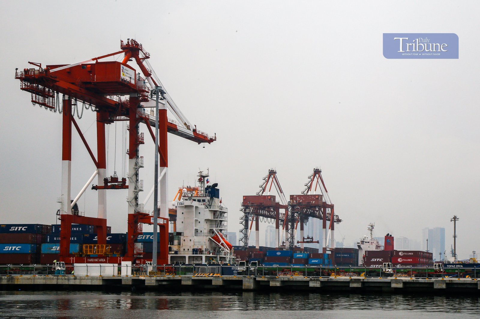 Heavy lifters load container vans onto a waiting trailer truck at a port terminal in Manila. The ongoing Iran-Israel conflict has notably affected Philippine imports and exports, mainly through disruptions in global oil prices, fertilizer supplies, and shipping routes.