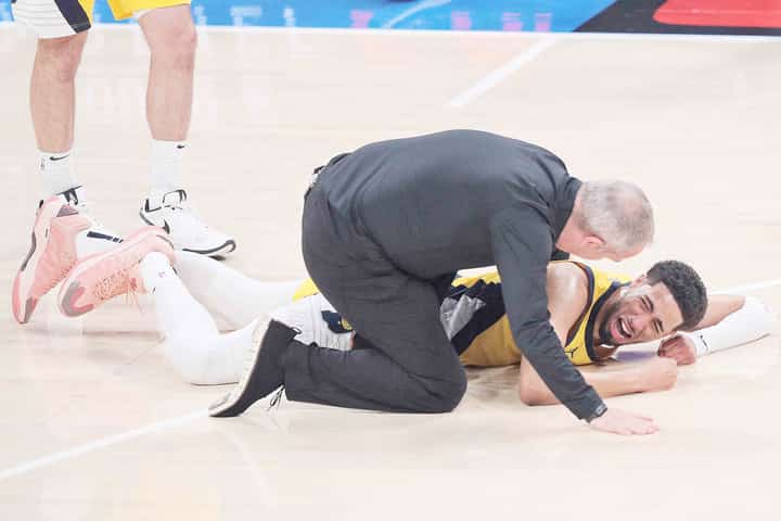 TYRESE Haliburton of the Indiana Pacers winces in pain after suffering a torn Achilles during their 91-103 loss to the Oklahoma City Thunder in Game 7 of the NBA Finals.