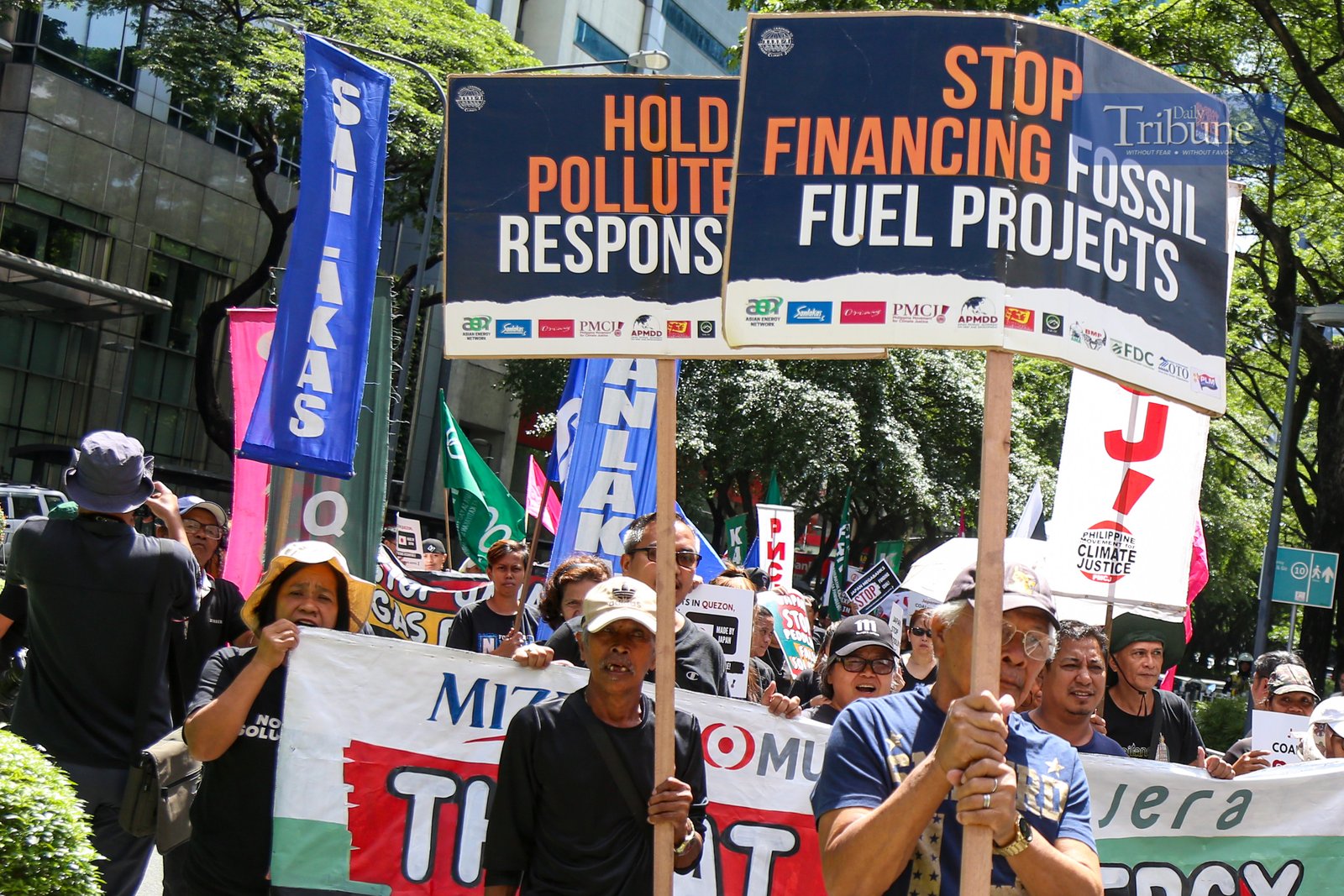 Climate advocates rally at the Ninoy Aquino Monument in Makati City on 24 June 2025, urging the Japanese government and its financiers to end support for coal and other fossil fuel projects in the Philippines and across Asia. They call instead for stronger investments in renewable energy like solar and wind.
