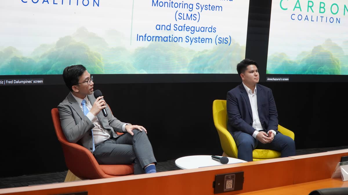 Atty. Ray Thomas Kabigting (left), assistant director of the DENR Forest Management Bureau, and Luke Joshua Castro, project development officer of FMB's forest investment development division, interact with the audience during the CarbonPH Coalition Education Series at the Aboitiz Tech Space of the Asian Insitute of Managerment on 23 June 2025.
