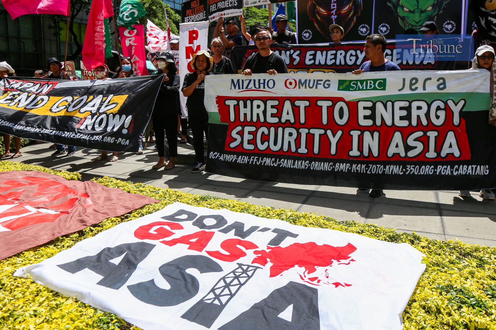 Climate advocates rally at the Ninoy Aquino Monument in Makati City on 24 June 2025, urging the Japanese government and its financiers to end support for coal and other fossil fuel projects in the Philippines and across Asia. They call instead for stronger investments in renewable energy like solar and wind.