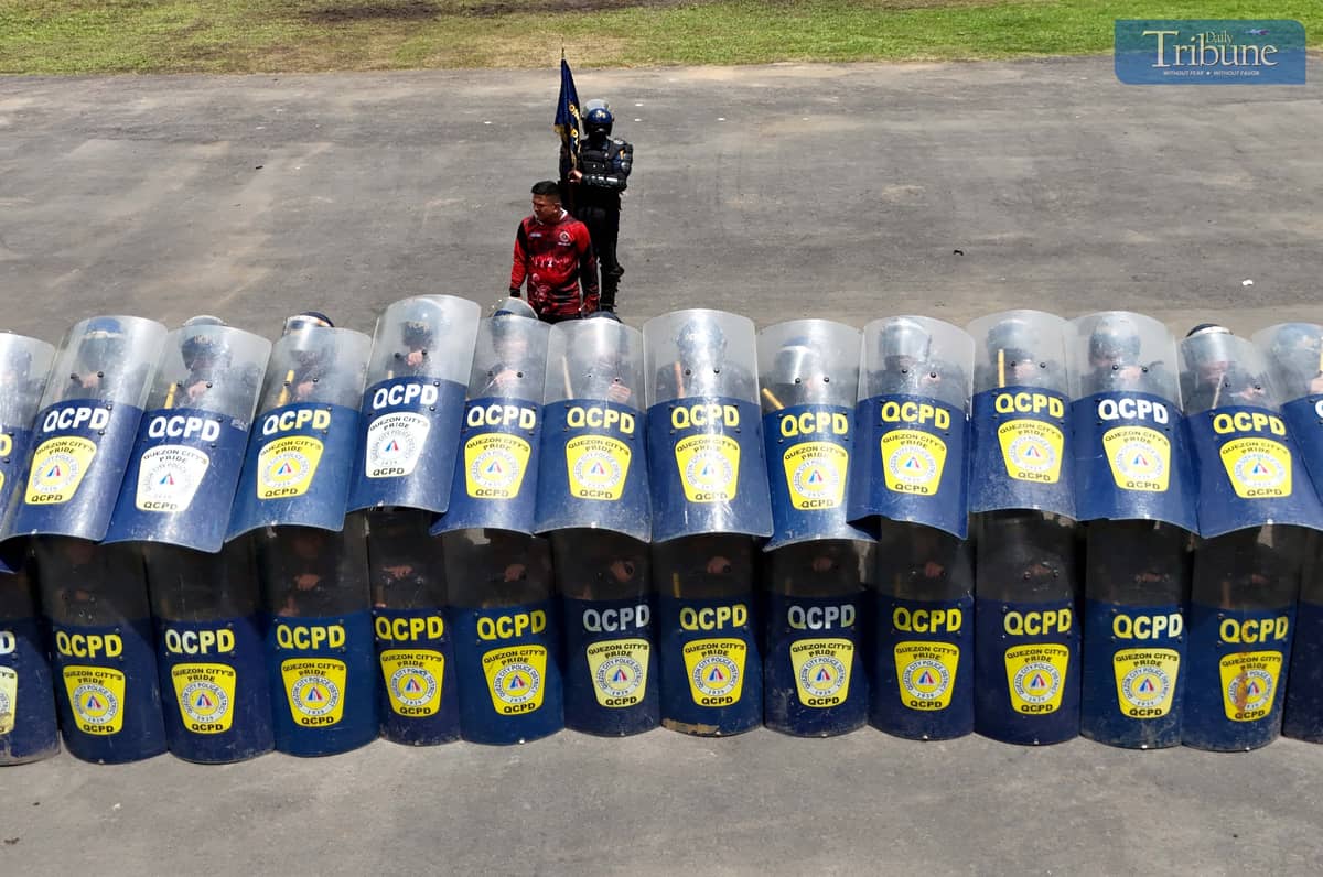 READY FOR ACTION. Members of the Quezon City Police District’s Civil Disturbance Management (CDM) unit rehearse their formation at Camp Karingal Grandstand on Wednesday, June 25, 2025. The team is gearing up for the CDM competition against other Metro Manila police districts, to be held at the NCRPO headquarters in Taguig City on July 3.