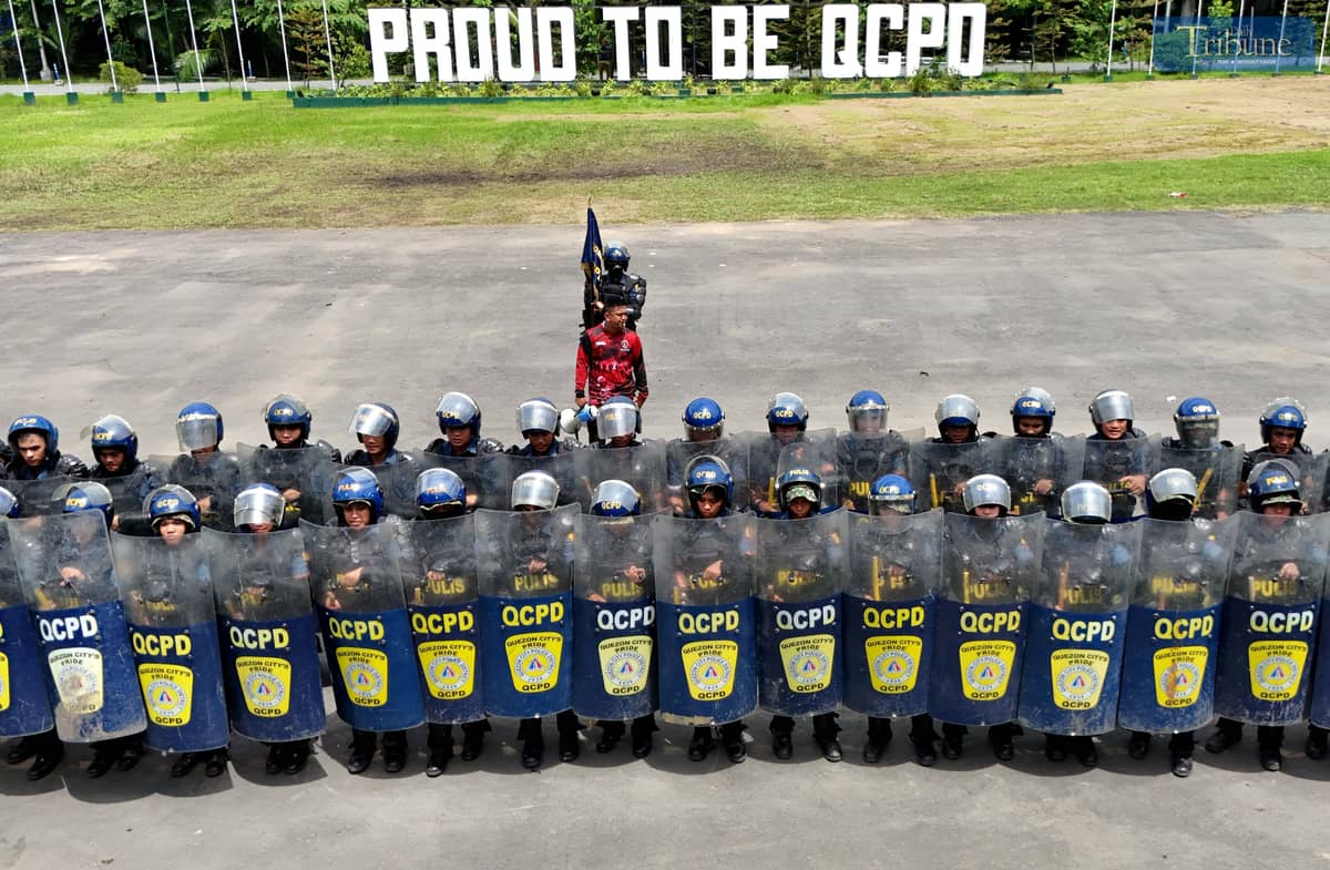 READY FOR ACTION. Members of the Quezon City Police District’s Civil Disturbance Management (CDM) unit rehearse their formation at Camp Karingal Grandstand on Wednesday, June 25, 2025. The team is gearing up for the CDM competition against other Metro Manila police districts, to be held at the NCRPO headquarters in Taguig City on July 3.