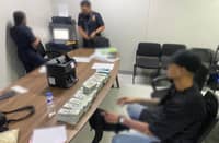 A male passenger (right, wearing a cap) was intercepted by airport authorities after being caught with P1.2 million and USD580,000 in undeclared cash at NAIA Terminal 3.
