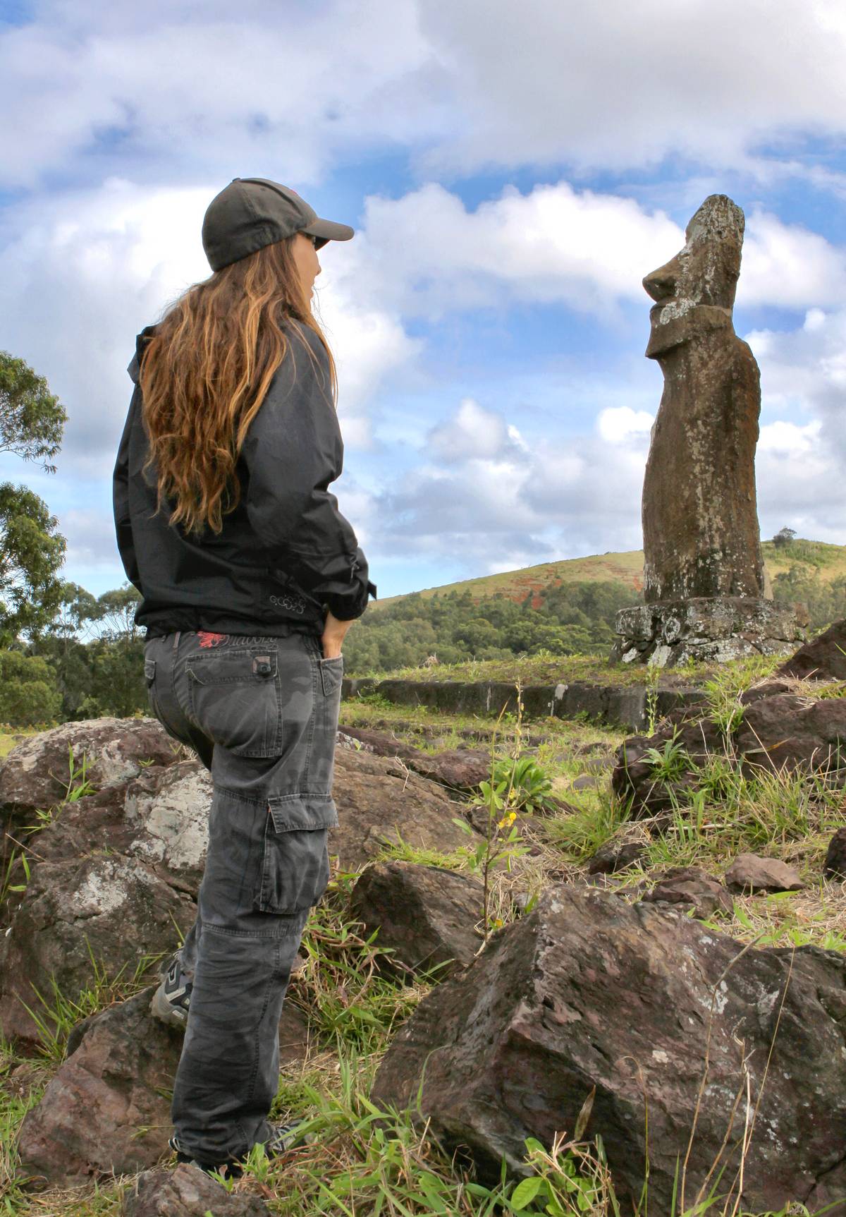 A local guide gazes at the moai.