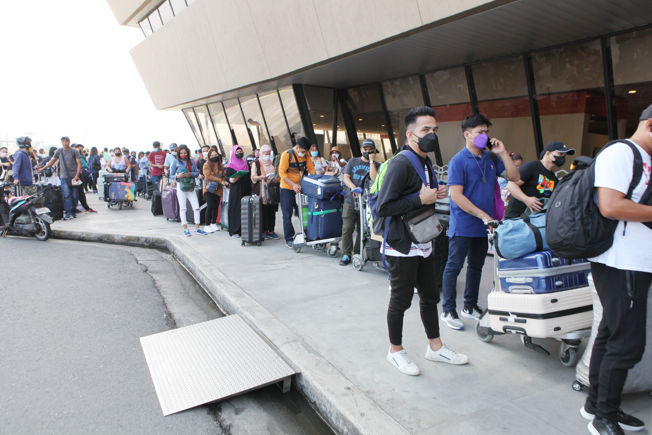 Filipinos scheduled for international travel line up at Ninoy Aquino International Airport Terminal 1.
